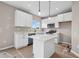 Kitchen with white cabinets, a stainless steel microwave, and a central island at 61 Okeechobee Way, Braselton, GA 30548