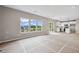 Open-concept living space featuring a kitchen with modern appliances and large windows for ample natural light at 61 Okeechobee Way, Braselton, GA 30548