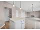 Open-concept area featuring a quartz island, a fireplace, and a stylish chandelier at 61 Okeechobee Way, Braselton, GA 30548