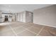 Open-concept living space with kitchen island, modern appliances, and access to the second floor via stairs at 61 Okeechobee Way, Braselton, GA 30548