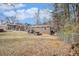 Expansive backyard with mature trees, fire pit and seating area, perfect for outdoor gatherings at 6355 Queens Rd, Douglasville, GA 30135