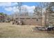 This backyard has a fire pit area, a small deck, and a brick home at 6355 Queens Rd, Douglasville, GA 30135