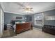 Bedroom features a large window, ceiling fan and carpeted floors at 6355 Queens Rd, Douglasville, GA 30135