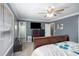 Spacious bedroom with a large window, ceiling fan, and dark walls at 6355 Queens Rd, Douglasville, GA 30135