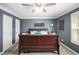 Bedroom with a ceiling fan and dark gray walls at 6355 Queens Rd, Douglasville, GA 30135
