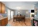 Open dining area with hardwood floors leading to a living room with a cozy fireplace at 6355 Queens Rd, Douglasville, GA 30135