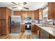A full kitchen view with stainless steel appliances, wooden cabinets and hardwood floors at 6355 Queens Rd, Douglasville, GA 30135