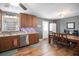 Kitchen area featuring wood cabinets, stainless steel dishwasher, and an adjacent dining area at 6355 Queens Rd, Douglasville, GA 30135