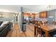 Open kitchen with wood cabinets, stainless steel appliances, and adjacent dining area at 6355 Queens Rd, Douglasville, GA 30135