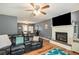 Spacious living room featuring a fireplace, ceiling fan, and wood-style flooring at 6355 Queens Rd, Douglasville, GA 30135