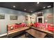Media room features leather sofas with Georgia themed pillows, Coca-Cola signage, and dark colored ceiling at 6355 Queens Rd, Douglasville, GA 30135