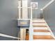 A charming staircase with white railings and hardwood steps leads to the upper level at 6355 Queens Rd, Douglasville, GA 30135