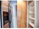 Close up of kitchen with stainless steel refrigerator and a walk in pantry with white shelves at 123 Luckie Nw St # 2510, Atlanta, GA 30303