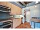Modern kitchen with stainless steel appliances, granite countertops and backsplash and concrete ceiling at 123 Luckie Nw St # 2510, Atlanta, GA 30303
