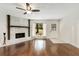 Corner view of living room with hardwood floors, stone fireplace, and window views to the outside at 4575 Jamerson Forest Pkwy, Marietta, GA 30066