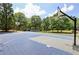 A full outdoor basketball court surrounded by trees and greenery at 755 Creek Wind Ct, Johns Creek, GA 30097