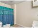 Simple bathroom with a tile floor, shower curtain and white sink at 755 Creek Wind Ct, Johns Creek, GA 30097