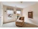 Bright bedroom featuring a chaise lounge, natural light, and scenic views, offering a peaceful and comfortable setting at 755 Creek Wind Ct, Johns Creek, GA 30097