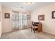 Cozy bedroom with neutral walls, carpet, and a desk near the window with floral curtains at 755 Creek Wind Ct, Johns Creek, GA 30097