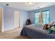 Comfortable bedroom with a cozy bed, large window, and soft blue walls, creating a relaxing retreat at 755 Creek Wind Ct, Johns Creek, GA 30097