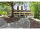 Inviting clubhouse with a charming wraparound porch and manicured landscaping at 755 Creek Wind Ct, Johns Creek, GA 30097