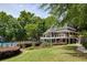 Beautiful clubhouse overlooking the pool with manicured lawn and landscaping at 755 Creek Wind Ct, Johns Creek, GA 30097