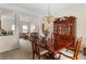 Elegant dining room with a polished wood table and chairs under a chandelier at 755 Creek Wind Ct, Johns Creek, GA 30097