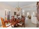 Elegant dining room with a polished wood table and chairs under a chandelier at 755 Creek Wind Ct, Johns Creek, GA 30097