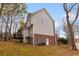 Well-maintained exterior of home with a deck and lush green lawn at 755 Creek Wind Ct, Johns Creek, GA 30097