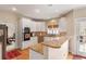 Well-lit kitchen with granite countertops, stainless steel appliances, and access to the outdoor deck area at 755 Creek Wind Ct, Johns Creek, GA 30097