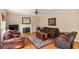 Cozy living room featuring hardwood floors, fireplace, and comfortable seating, creating a warm and inviting atmosphere at 755 Creek Wind Ct, Johns Creek, GA 30097
