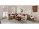 Inviting living room featuring a comfortable sofa, stylish decor, and natural light at 755 Creek Wind Ct, Johns Creek, GA 30097