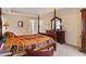 Spacious main bedroom with a four-poster bed, dresser, and neutral walls at 755 Creek Wind Ct, Johns Creek, GA 30097