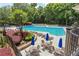 Aerial view of the community pool with chairs, tables and umbrellas at 755 Creek Wind Ct, Johns Creek, GA 30097