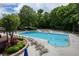 Community pool with lounge chairs, lush landscape and a serene setting at 755 Creek Wind Ct, Johns Creek, GA 30097