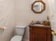Elegant powder room with carved vanity, marble countertop, decorative mirror, and stylish fixtures at 755 Creek Wind Ct, Johns Creek, GA 30097
