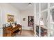 Cozy room with neutral walls featuring a piano, artwork, and comfortable seating area at 755 Creek Wind Ct, Johns Creek, GA 30097