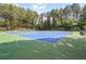 Well-maintained community tennis court surrounded by mature trees at 755 Creek Wind Ct, Johns Creek, GA 30097