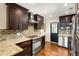 Updated kitchen with stainless steel appliances, granite counters, and a convenient exterior door at 1526 Stone Gate Se Ln, Atlanta, GA 30317