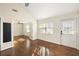 Sunlit living room with gleaming hardwood floors, modern lighting, and an open doorway at 1526 Stone Gate Se Ln, Atlanta, GA 30317