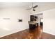 Hardwood living room showcasing ceiling fan, light walls, and an open floor plan to the kitchen at 1526 Stone Gate Se Ln, Atlanta, GA 30317