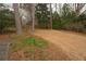 Large backyard with grass and surrounding mature trees at 1728 Stonecliff Ct, Decatur, GA 30033