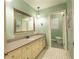 Bathroom featuring a long vanity and a separate toilet area with light green walls and patterned floor at 1728 Stonecliff Ct, Decatur, GA 30033