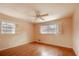 Bright bedroom with hardwood floors, ceiling fan, and shuttered windows at 1728 Stonecliff Ct, Decatur, GA 30033