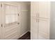 Mudroom entryway with tile floor, door with window and large white storage cabinet at 1728 Stonecliff Ct, Decatur, GA 30033