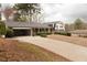 Spacious home featuring an attached carport and a long driveway at 1728 Stonecliff Ct, Decatur, GA 30033