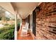 Covered porch with white rocking chairs and brick accents at 1728 Stonecliff Ct, Decatur, GA 30033