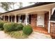 Inviting brick porch with rocking chairs and classic white columns at 1728 Stonecliff Ct, Decatur, GA 30033