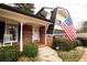 Front of house with charming porch and classic American flag at 1728 Stonecliff Ct, Decatur, GA 30033