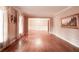 Living room with gleaming hardwood floors, bright walls, and large windows with curtains at 1728 Stonecliff Ct, Decatur, GA 30033